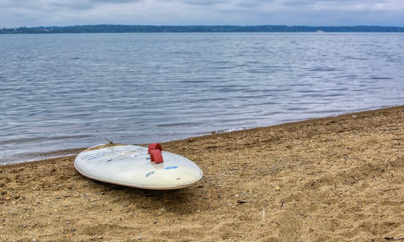 Ein Paddle Board am Ufer eines Sees.